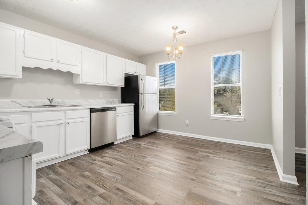 3521 Kingswood Trail Decatur, GA 30034 - Photo 13 of 26 a kitchen with stainless steel appliances granite countertop a stove a sink dishwasher and a refrigerator with wooden floor