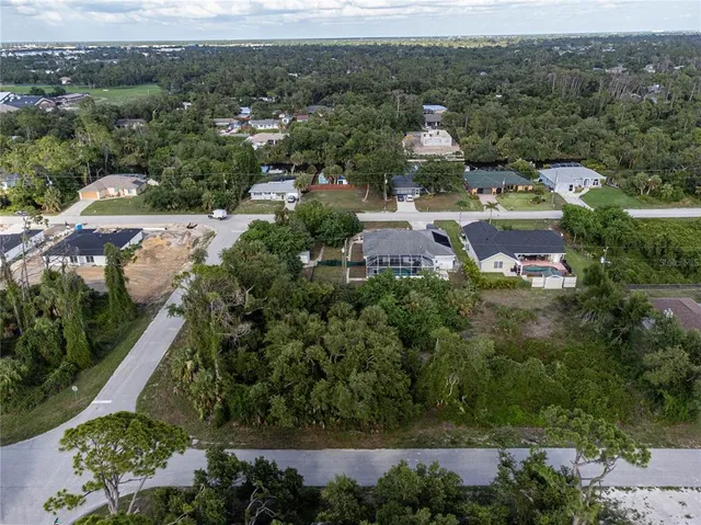 an aerial view of a house with lots of trees