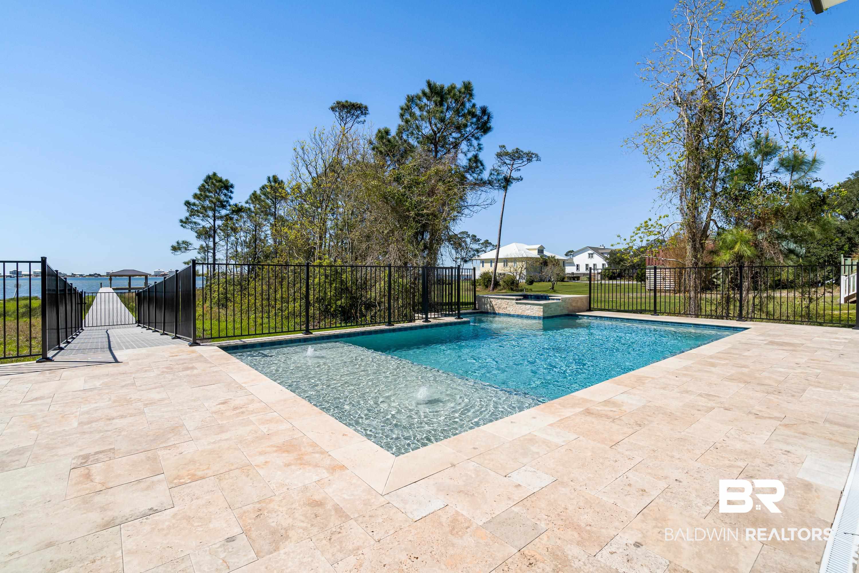 14686 State Highway Gulf Shores, AL 36542 - Photo 28 of 44 View of swimming pool featuring a patio, fence, and a pool with connected hot tub