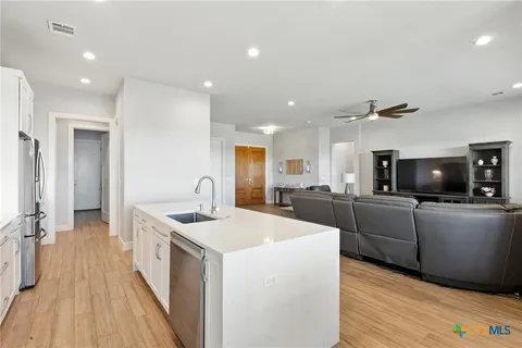 a kitchen with stainless steel appliances kitchen island a sink and a stove