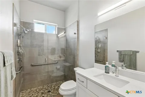a bathroom with a sink toilet and shower