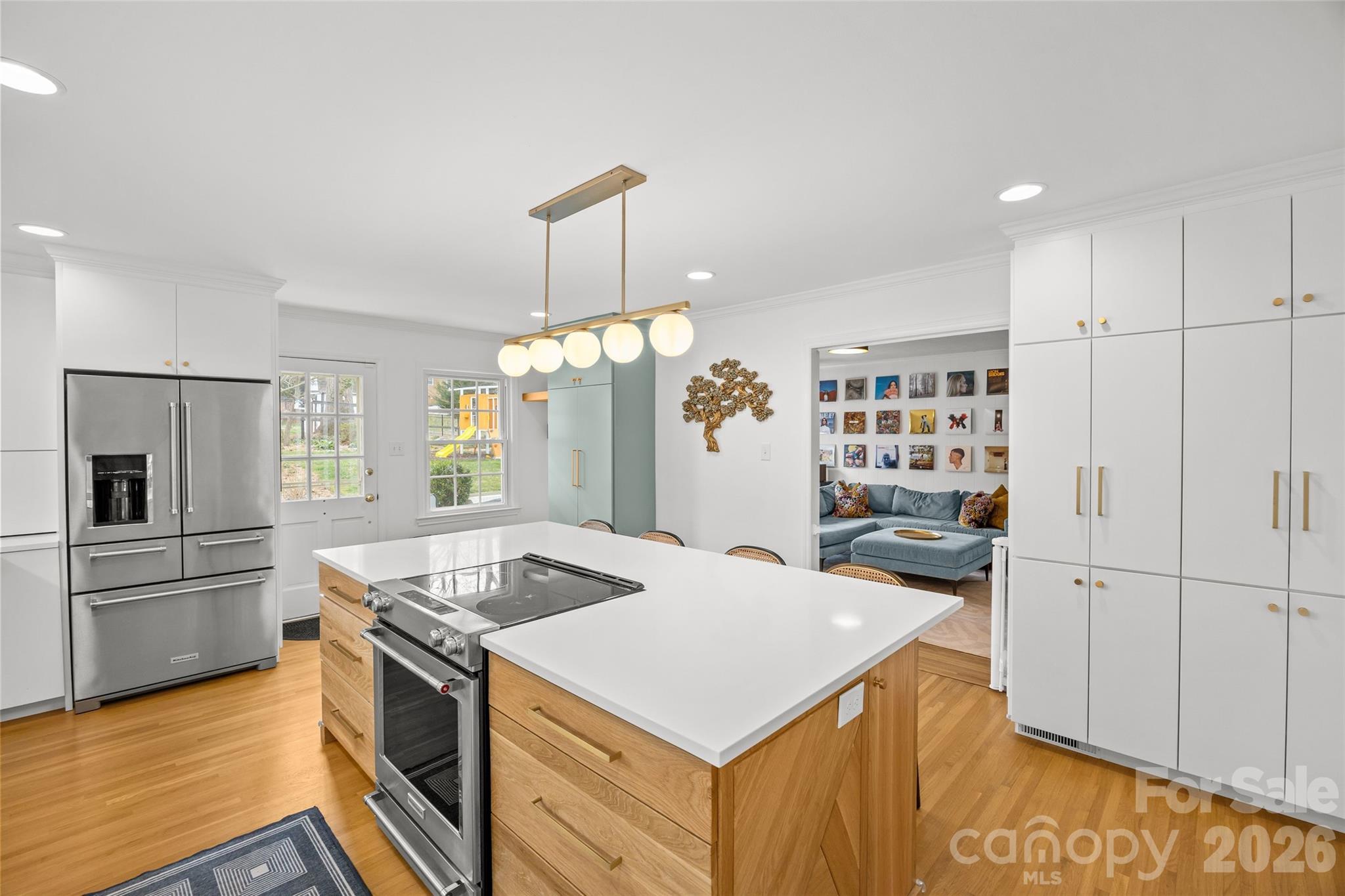 2732 Burnt Mill Road Charlotte, NC 28210 - Photo 16 of 43 a kitchen that has a kitchen island wooden floor and stainless steel appliances