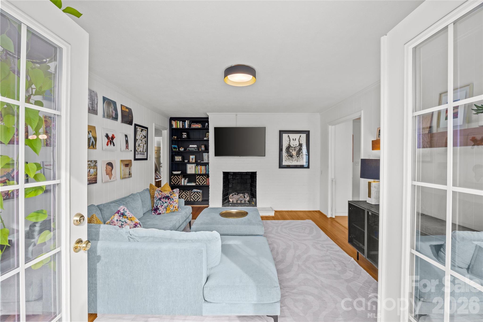 2732 Burnt Mill Road Charlotte, NC 28210 - Photo 21 of 43 a living room with furniture a fireplace and a flat screen tv