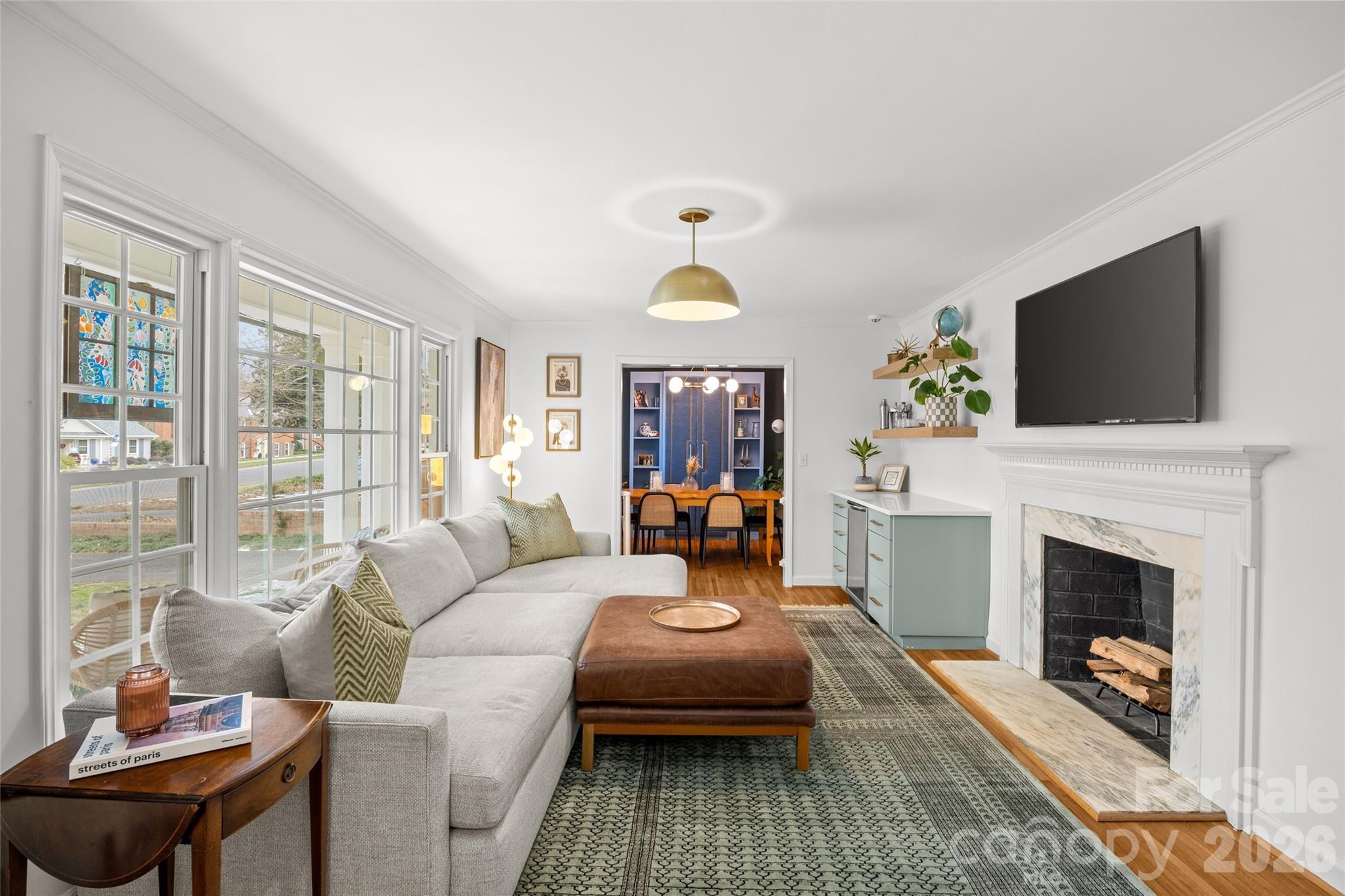 2732 Burnt Mill Road Charlotte, NC 28210 - Photo 6 of 43 a living room with furniture a flat screen tv and a fireplace