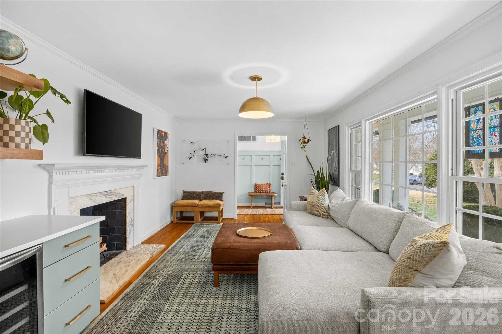 2732 Burnt Mill Road Charlotte, NC 28210 - Photo 8 of 43 a living room with furniture a fireplace and a flat screen tv