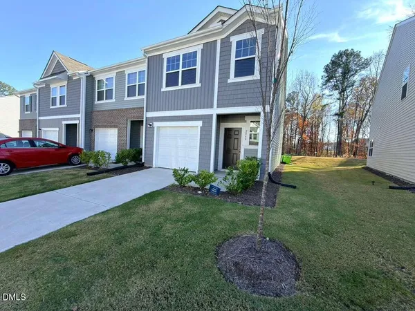 a view of a brick house with a yard