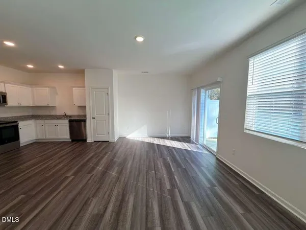 a view of a kitchen with wooden floor and electronic appliances