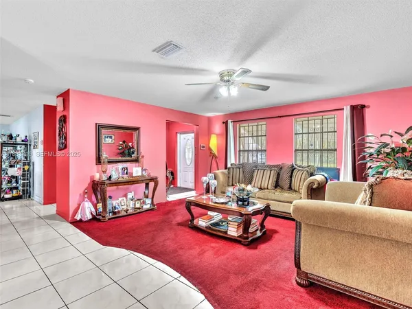 a living room with furniture and a floor to ceiling window