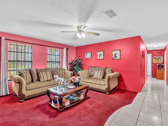 a living room with furniture rug and wooden floor