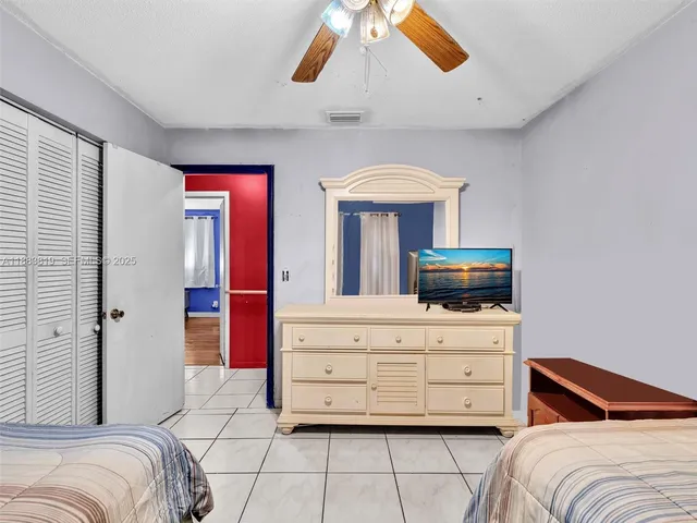 a bedroom with a bed and a television