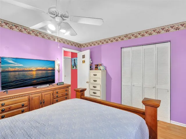 a bedroom with furniture and flat screen tv