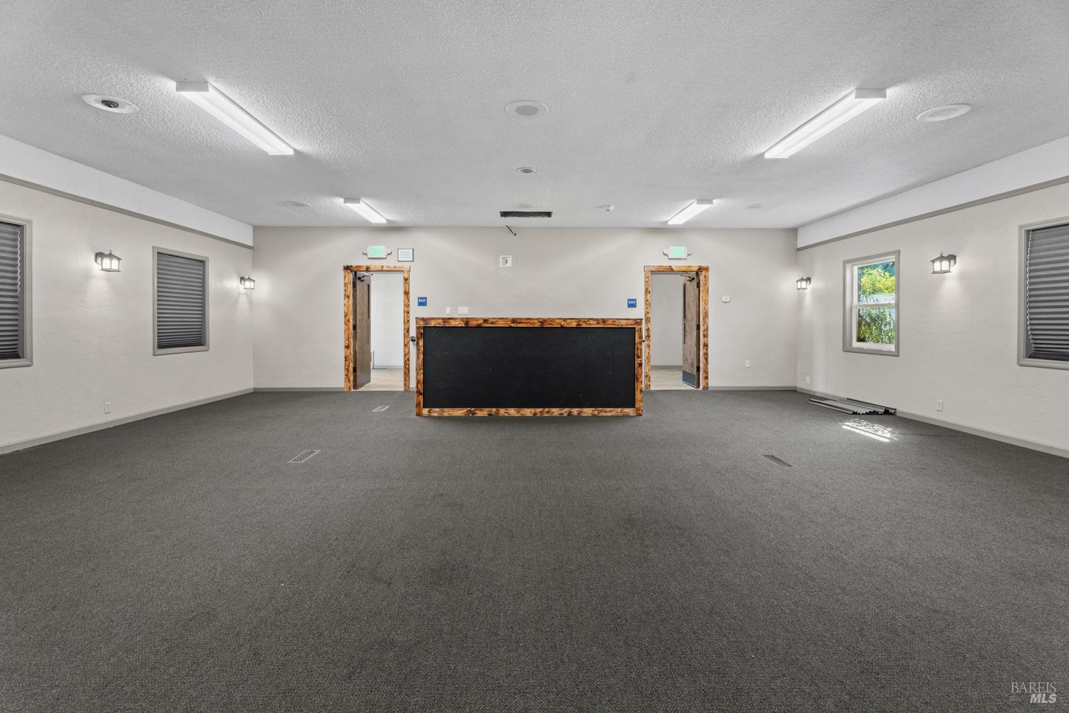 195 Low Gap Road Ukiah, CA 95482 - Photo 3 of 13 an empty room with windows and fireplace