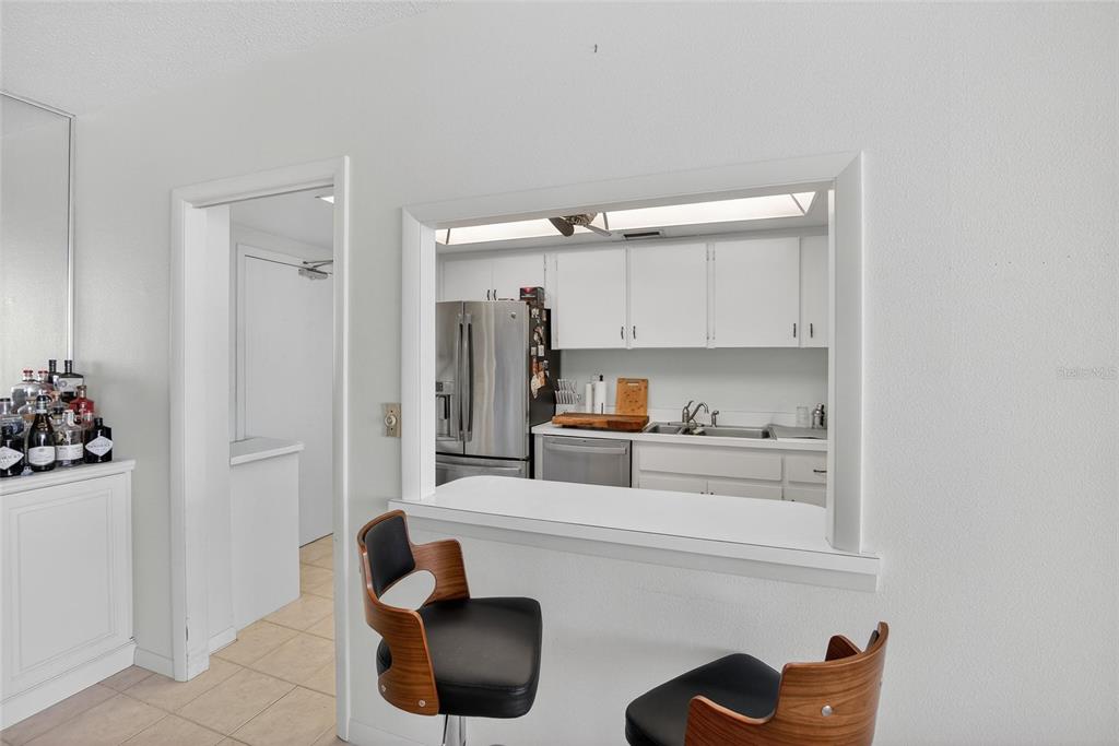 100 Pierce Street, Unit 703 Clearwater, FL 33756 - Photo 11 of 70 a kitchen with stainless steel appliances a refrigerator and cabinets