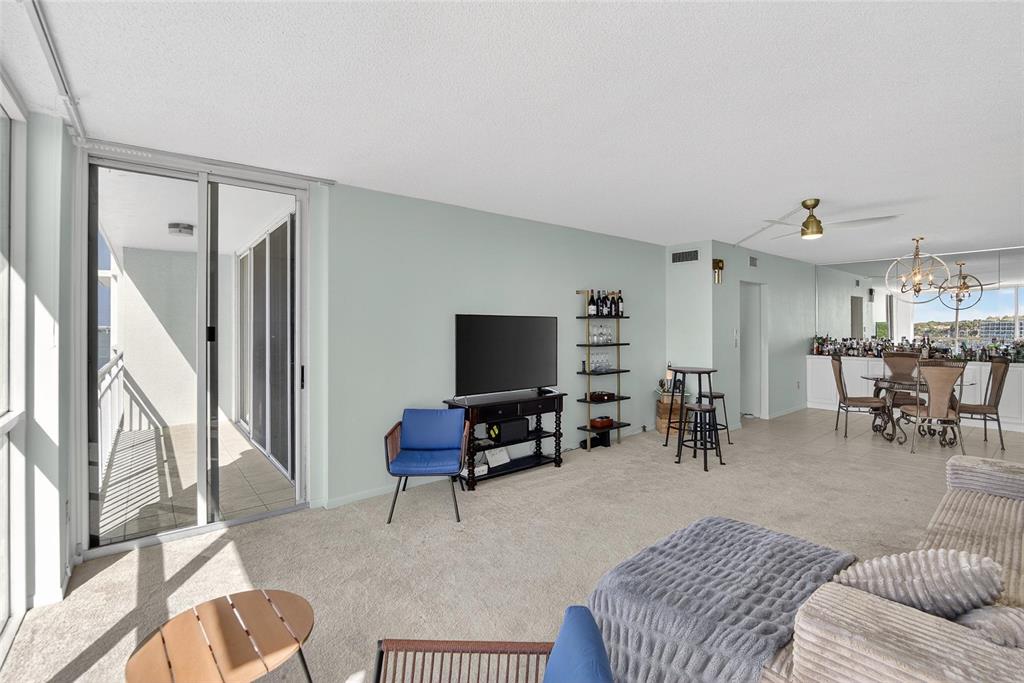 100 Pierce Street, Unit 703 Clearwater, FL 33756 - Photo 18 of 70 a living room with furniture and a flat screen tv with wooden floor
