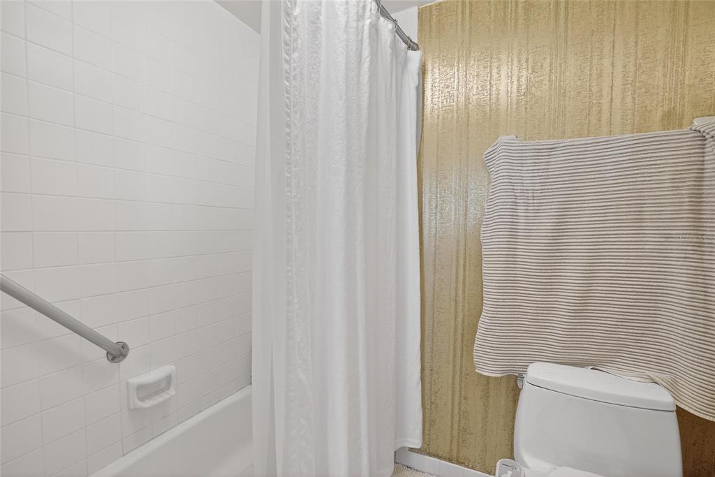 100 Pierce Street, Unit 703 Clearwater, FL 33756 - Photo 26 of 70 a bathroom with a shower curtain