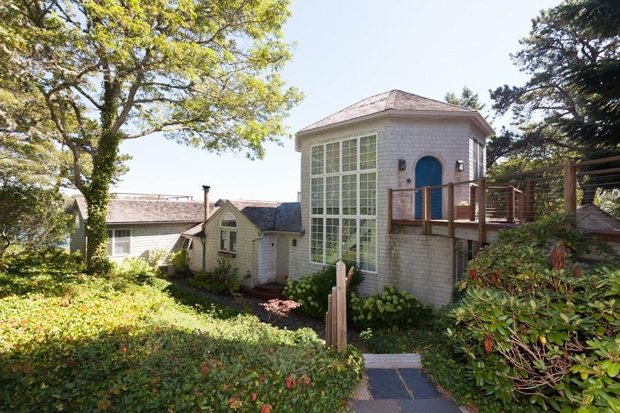 a front view of house with yard and trees around