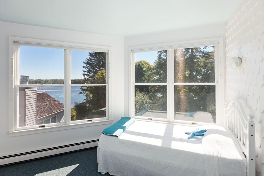 5 Kidd Way Orleans, MA 02653 - Photo 19 of 35 a living room with a large window and a table