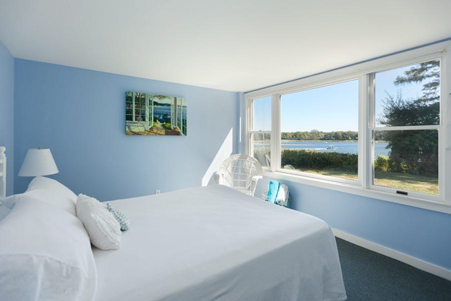 5 Kidd Way Orleans, MA 02653 - Photo 23 of 35 a bedroom with a bed and a large window with the outer view