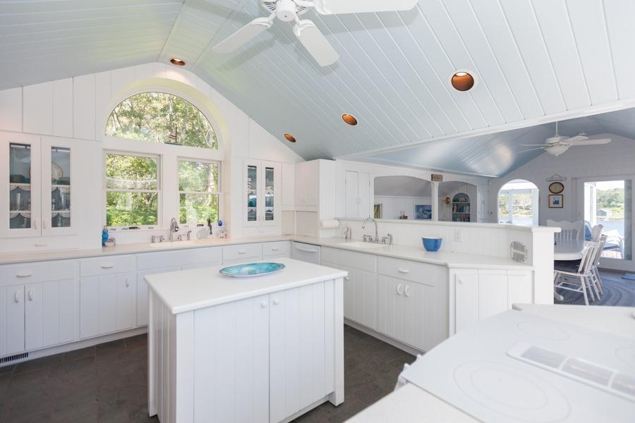 5 Kidd Way Orleans, MA 02653 - Photo 10 of 35 a kitchen with a sink a stove a refrigerator and white cabinets