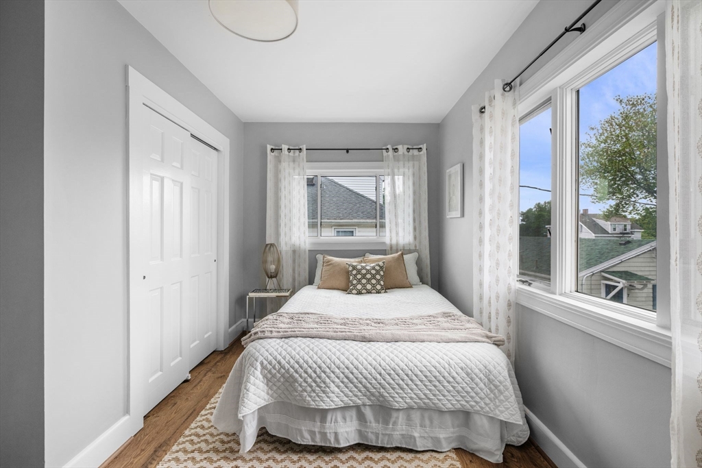 8 Baker Avenue Beverly, MA 01915 - Photo 19 of 40 a bedroom with a large bed and a large window with outer view