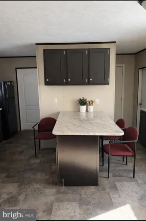 a kitchen with a table and chairs