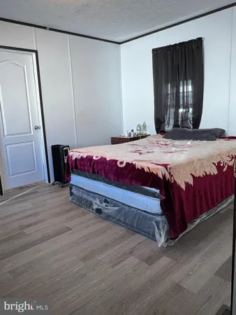 a bedroom with a bed and a mirror