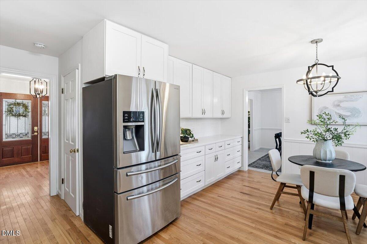 2828 McDowell Road Durham, NC 27705 - Photo 11 of 45 a kitchen with granite countertop stainless steel appliances a dining table chairs refrigerator and sink