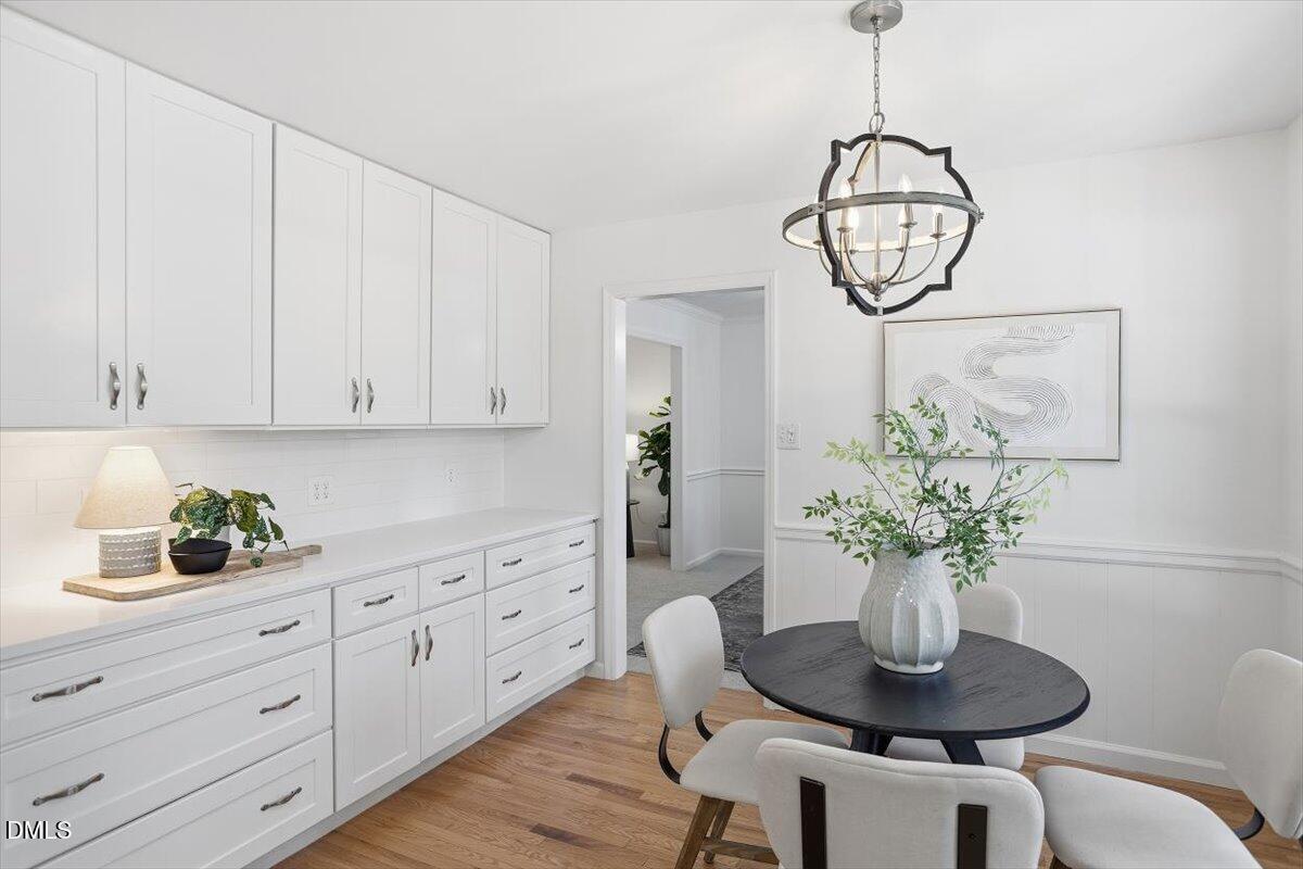 2828 McDowell Road Durham, NC 27705 - Photo 13 of 45 a kitchen with a table and a potted plant