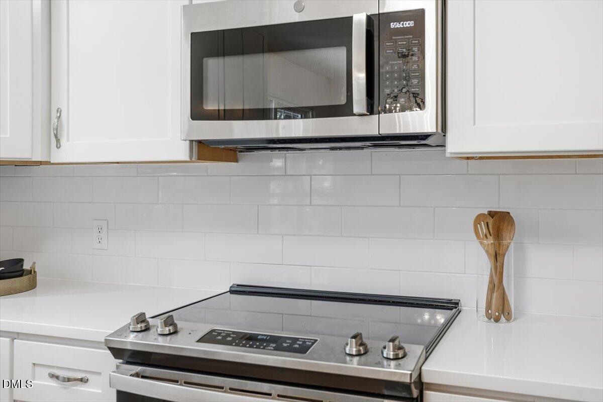 2828 McDowell Road Durham, NC 27705 - Photo 16 of 45 a close view of a stove a microwave and cabinets