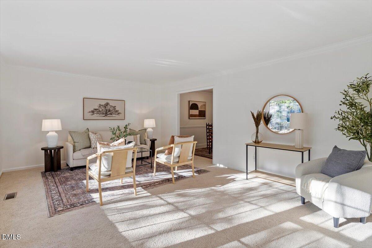 2828 McDowell Road Durham, NC 27705 - Photo 17 of 45 a living room with furniture a clock on wall and a table