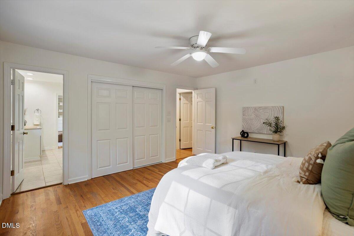 2828 McDowell Road Durham, NC 27705 - Photo 24 of 45 a bedroom with a bed and wooden floor