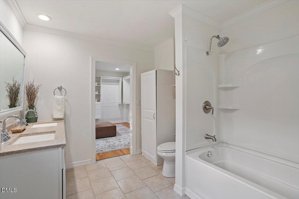 2828 McDowell Road Durham, NC 27705 - Photo 25 of 45 a bathroom with a granite countertop sink a toilet and shower