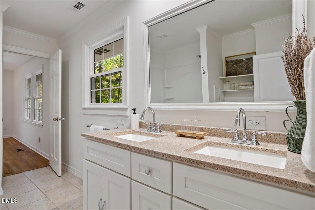2828 McDowell Road Durham, NC 27705 - Photo 26 of 45 a bathroom with double vanity and a mirror