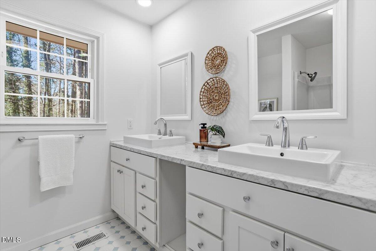 2828 McDowell Road Durham, NC 27705 - Photo 30 of 45 a bathroom with a sink and a mirror