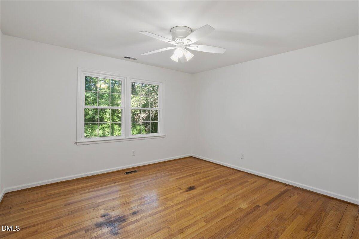 2828 McDowell Road Durham, NC 27705 - Photo 32 of 45 a view of an empty room with wooden floor and a window