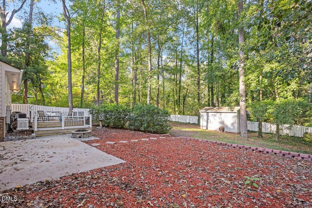 2828 McDowell Road Durham, NC 27705 - Photo 39 of 45 a view of a backyard with lawn chairs and large trees