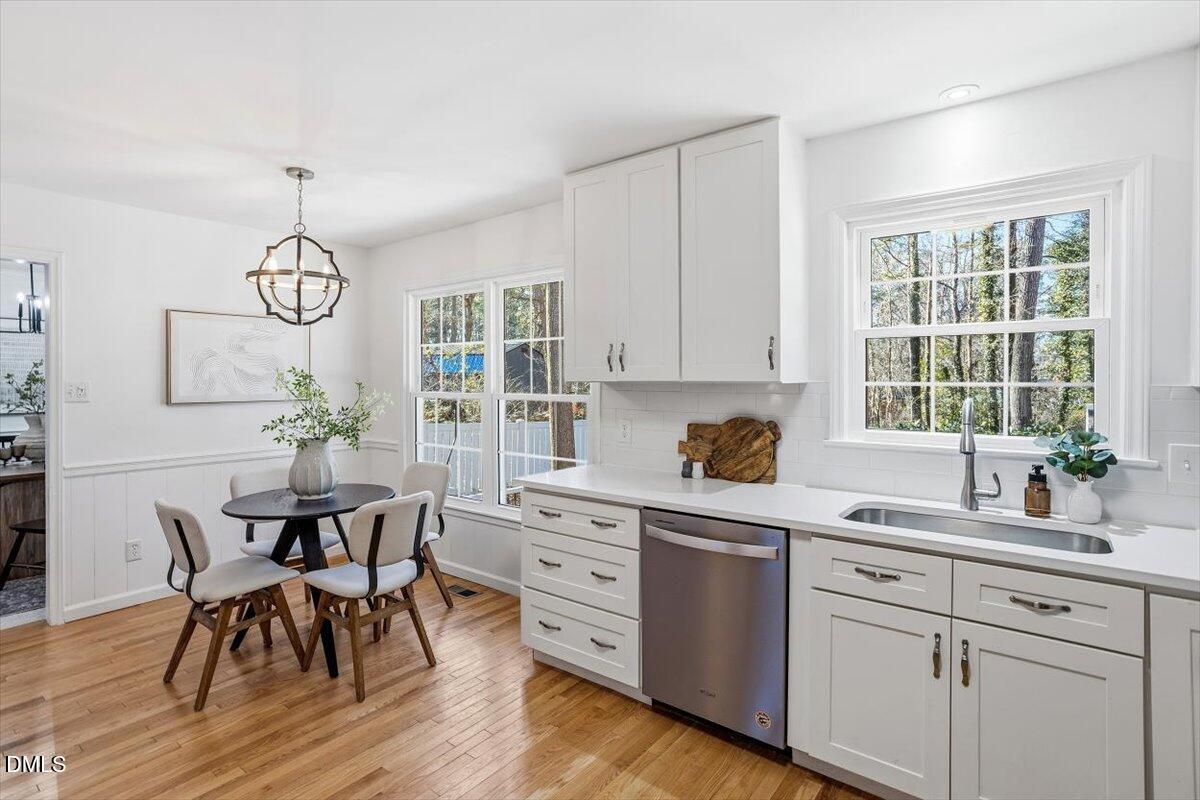 2828 McDowell Road Durham, NC 27705 - Photo 8 of 45 a kitchen with a table chairs and white cabinets