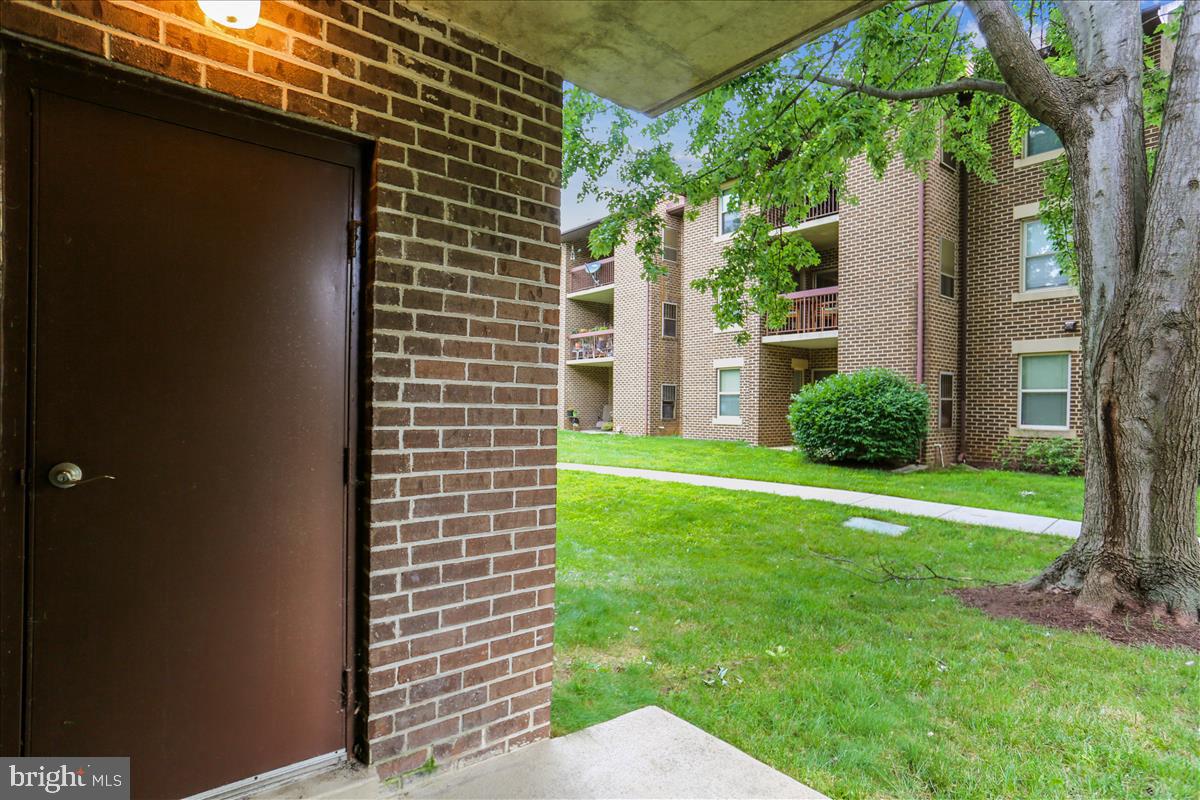 18401 Guildberry Drive, Unit 104 Gaithersburg, MD 20879 - Photo 19 of 24 a view of a backyard with plants and a tree