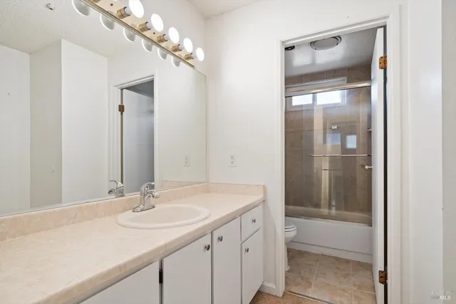 a bathroom with a sink double vanity and a mirror
