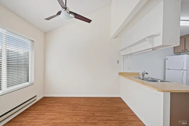 a view of a kitchen sink cabinets and window
