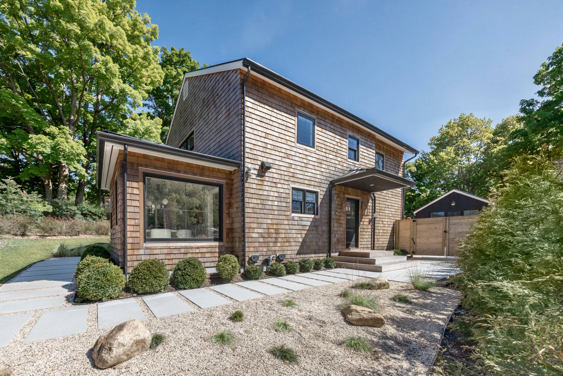 3058 Noyack Road Sag Harbor, NY 11963 - Photo 3 of 34 a front view of a house with garden