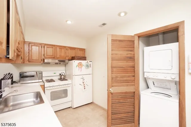 a kitchen with a stove a sink and a refrigerator