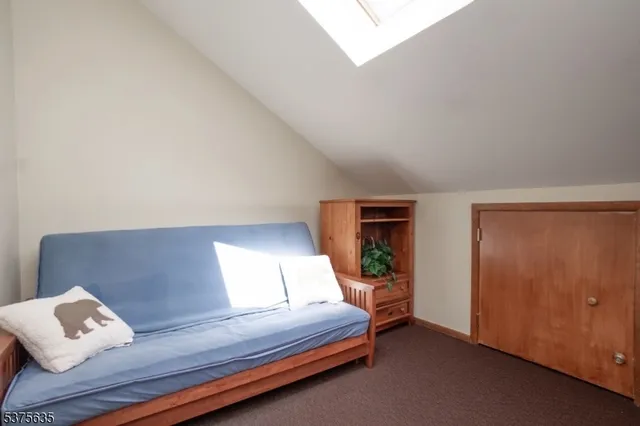 a bedroom with a bed and a night stand