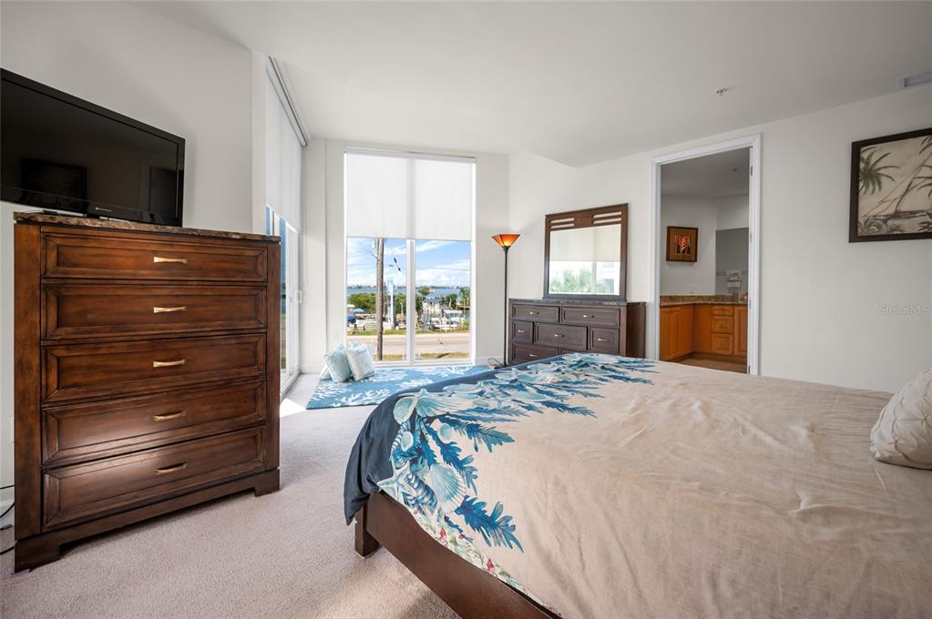 1375 Beach Road, Unit 112 Englewood, FL 34223 - Photo 12 of 50 a bedroom with a bed and a flat screen tv