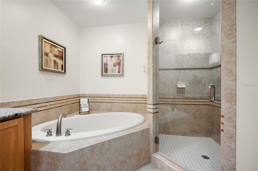 1375 Beach Road, Unit 112 Englewood, FL 34223 - Photo 16 of 50 a bathroom with a tub and a shower