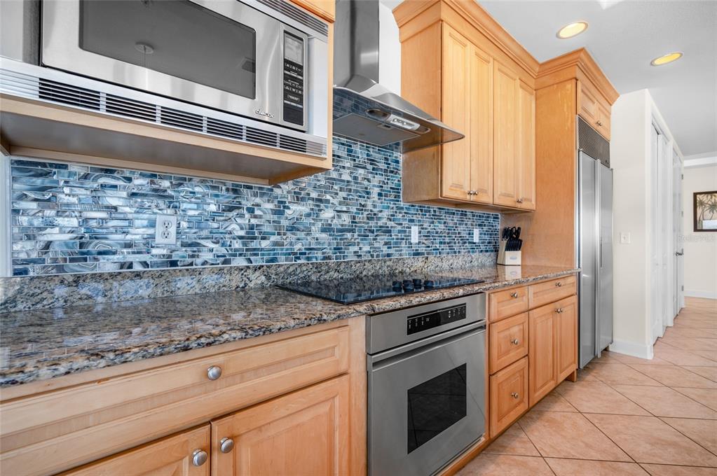 1375 Beach Road, Unit 112 Englewood, FL 34223 - Photo 25 of 50 a kitchen with granite countertop white cabinets stainless steel appliances and a counter space