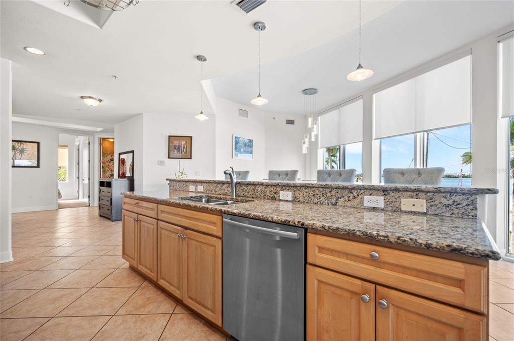 1375 Beach Road, Unit 112 Englewood, FL 34223 - Photo 26 of 50 a large kitchen with granite countertop a sink and cabinets