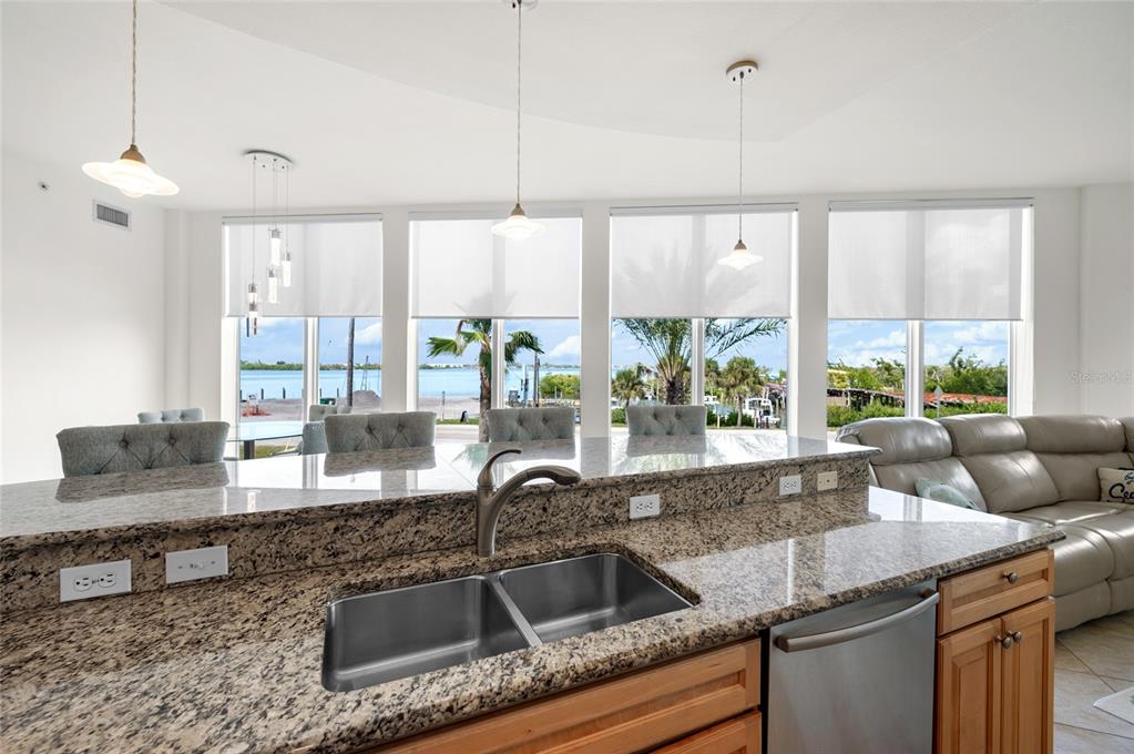 1375 Beach Road, Unit 112 Englewood, FL 34223 - Photo 3 of 50 a kitchen with granite countertop a sink and a counter top space