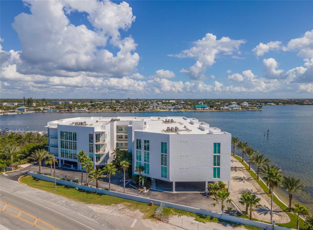 1375 Beach Road, Unit 112 Englewood, FL 34223 - Photo 45 of 50 a view of a lake with a building in front of it