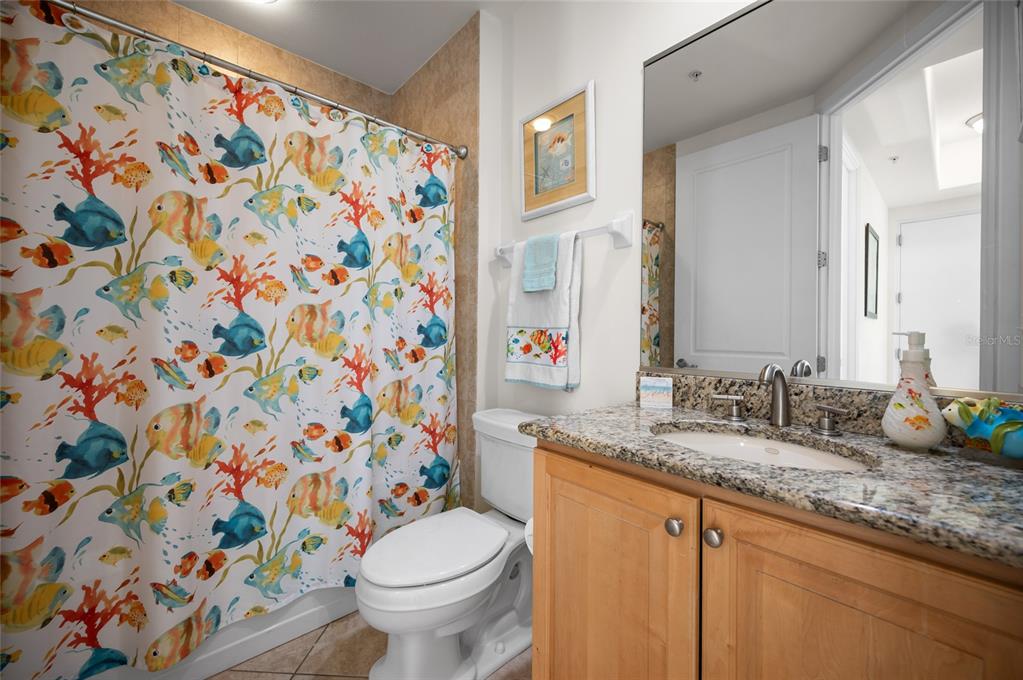 1375 Beach Road, Unit 112 Englewood, FL 34223 - Photo 9 of 50 a bathroom with a granite countertop sink and a toilet